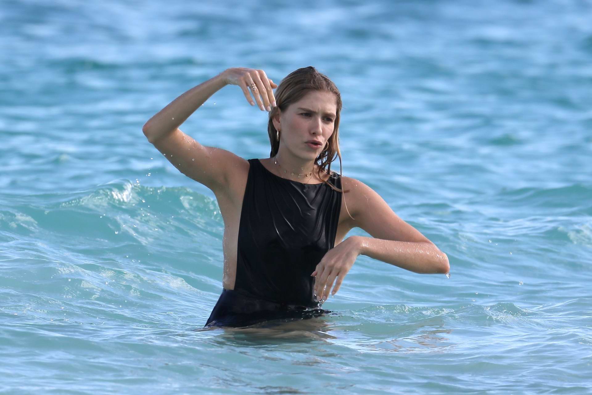 elena perminova goes for a swim in a black swimsuit during her vacation