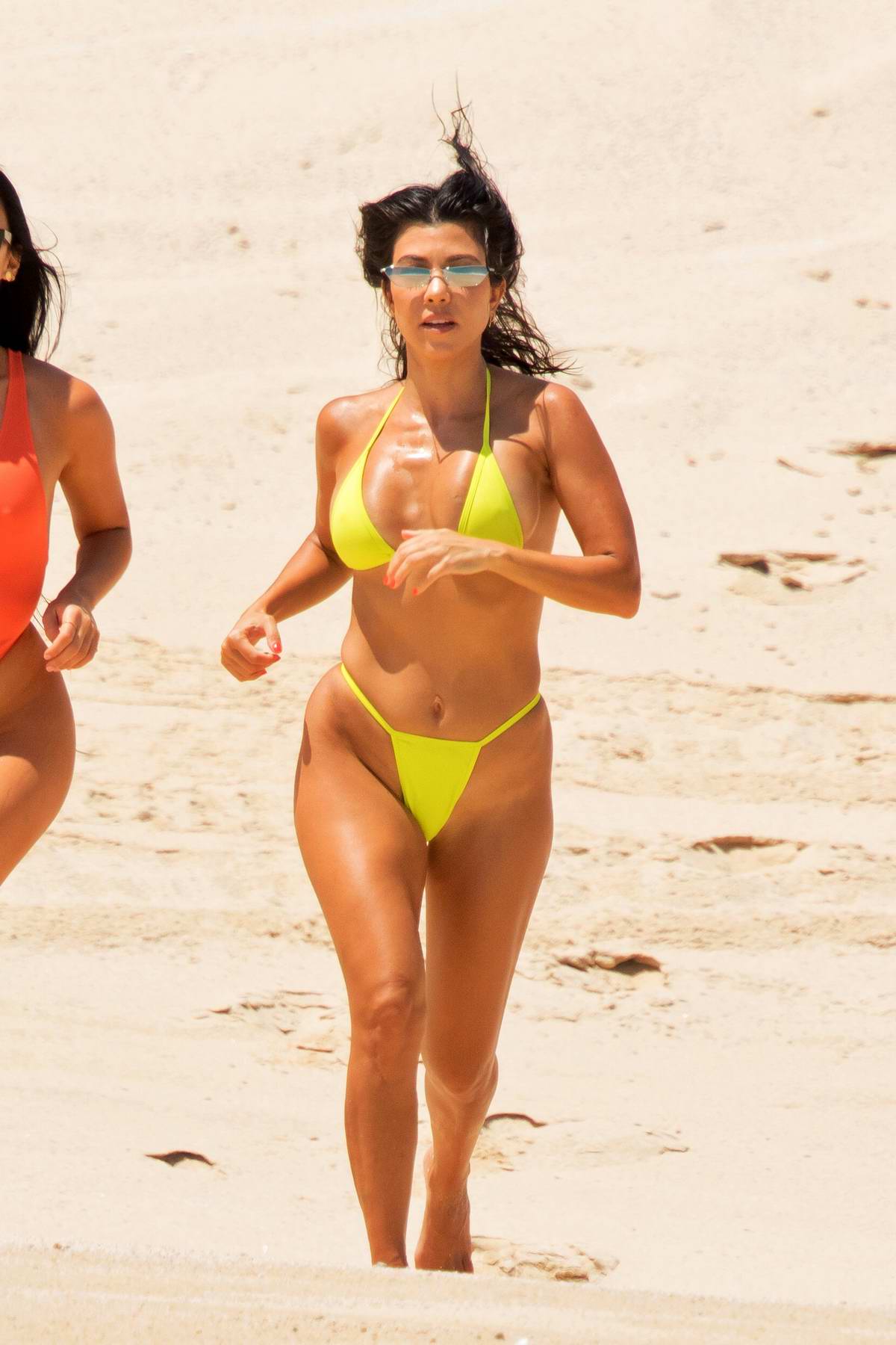Kourtney Kardashian Wears A Yellow Bikini As She Hits The Beach With
