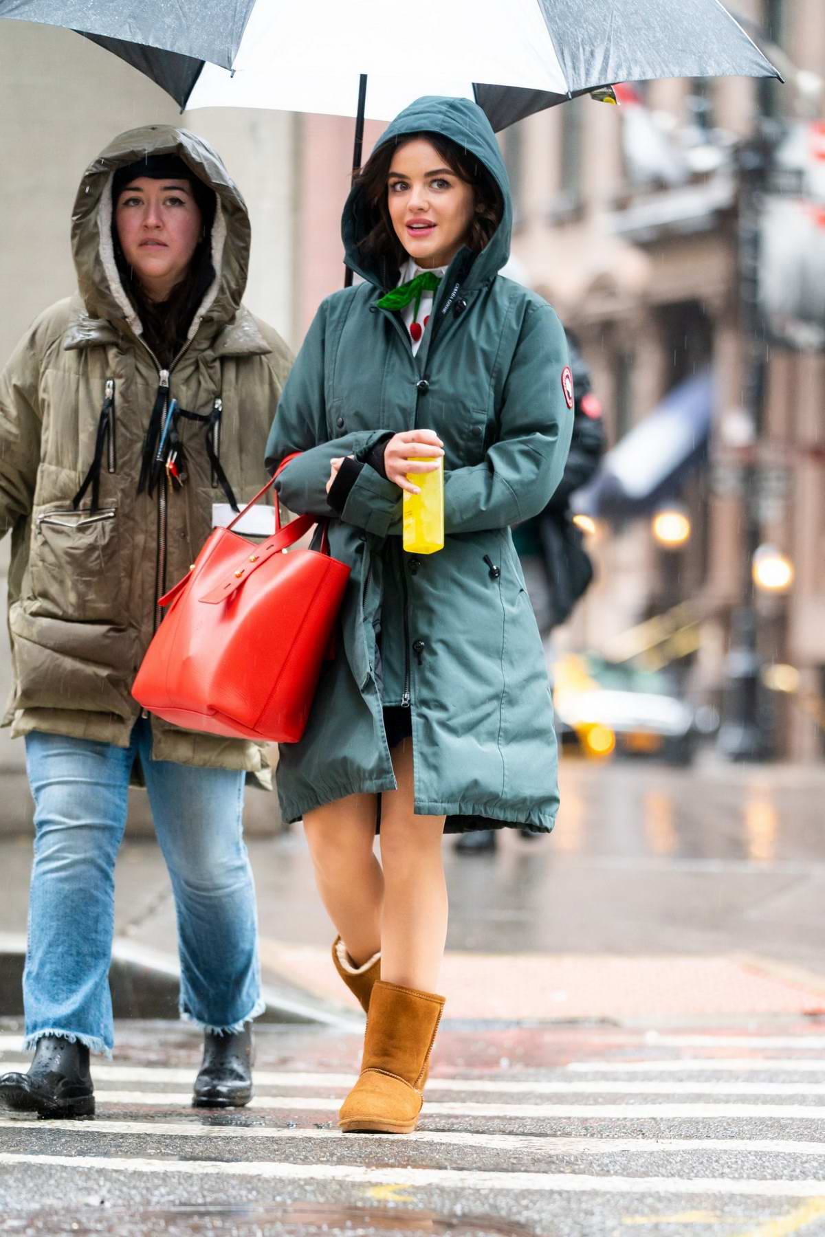 Lucy Hale braves the rain with a green 
