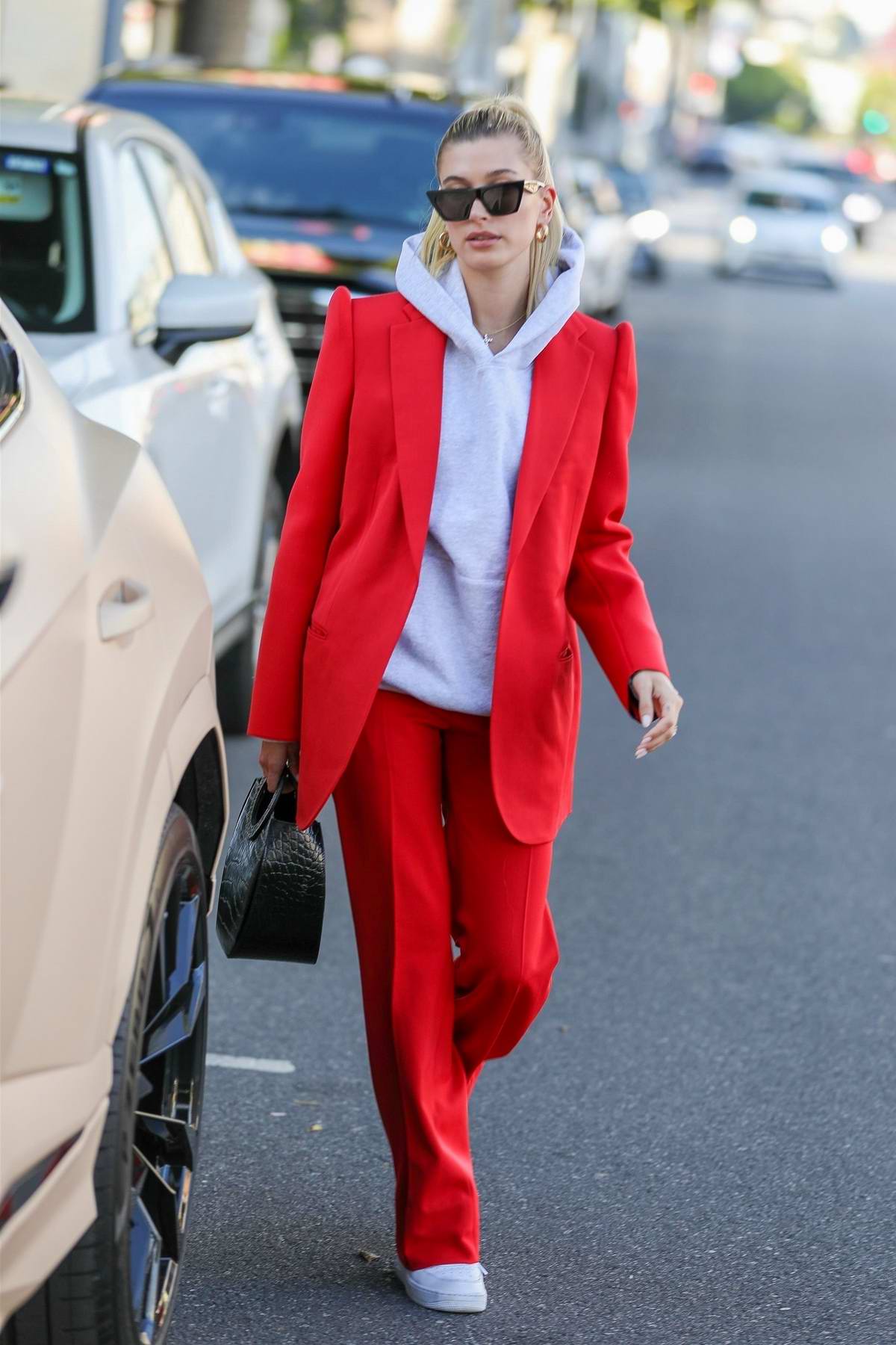 Hailey Bieber Looks Trendy In A Red Suit With A Hoodie As She Steps Out In Beverly Hills Los