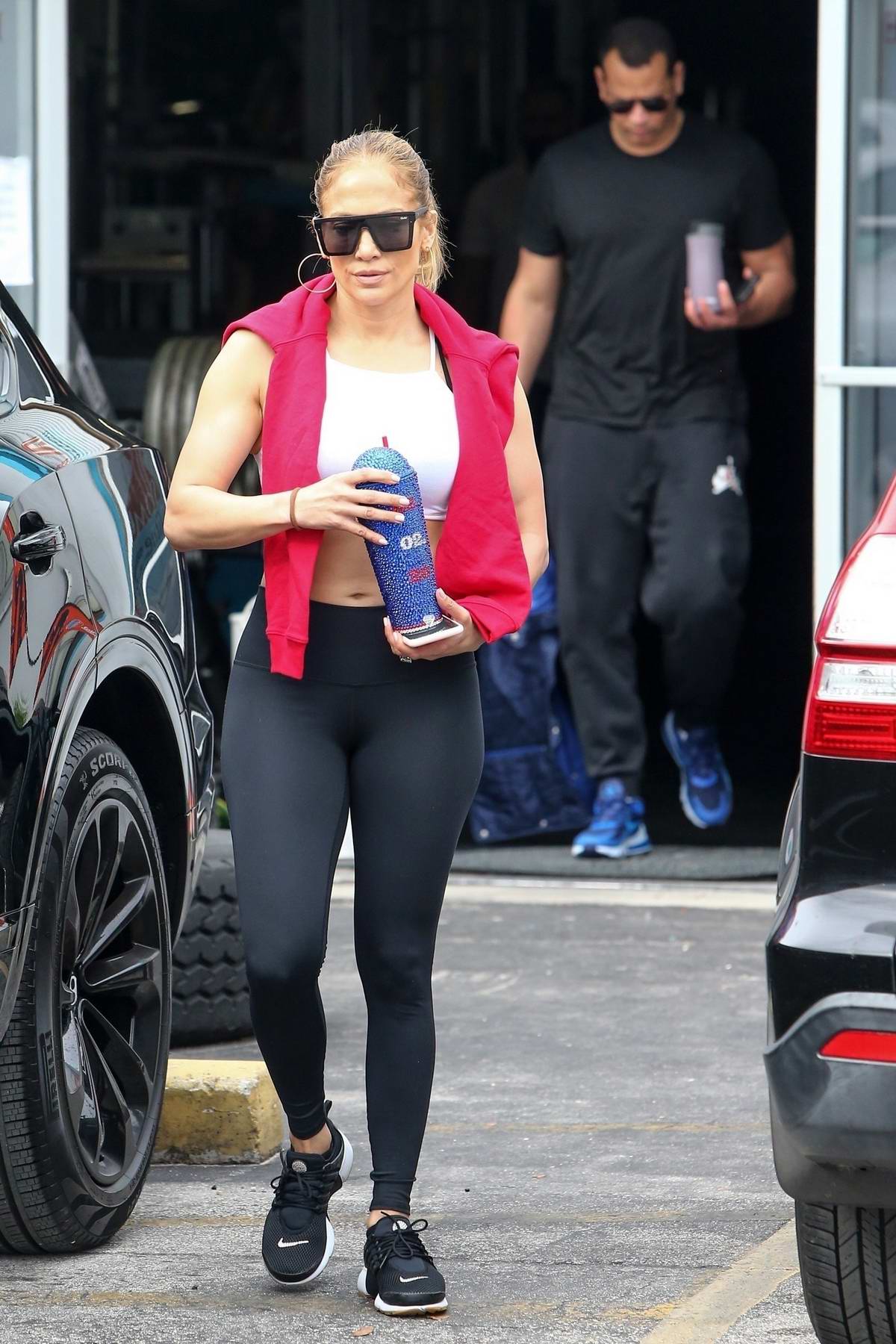 Jennifer Lopez Shows Off Her Fit Physique In A White Crop Top And Black Leggings As She Leaves