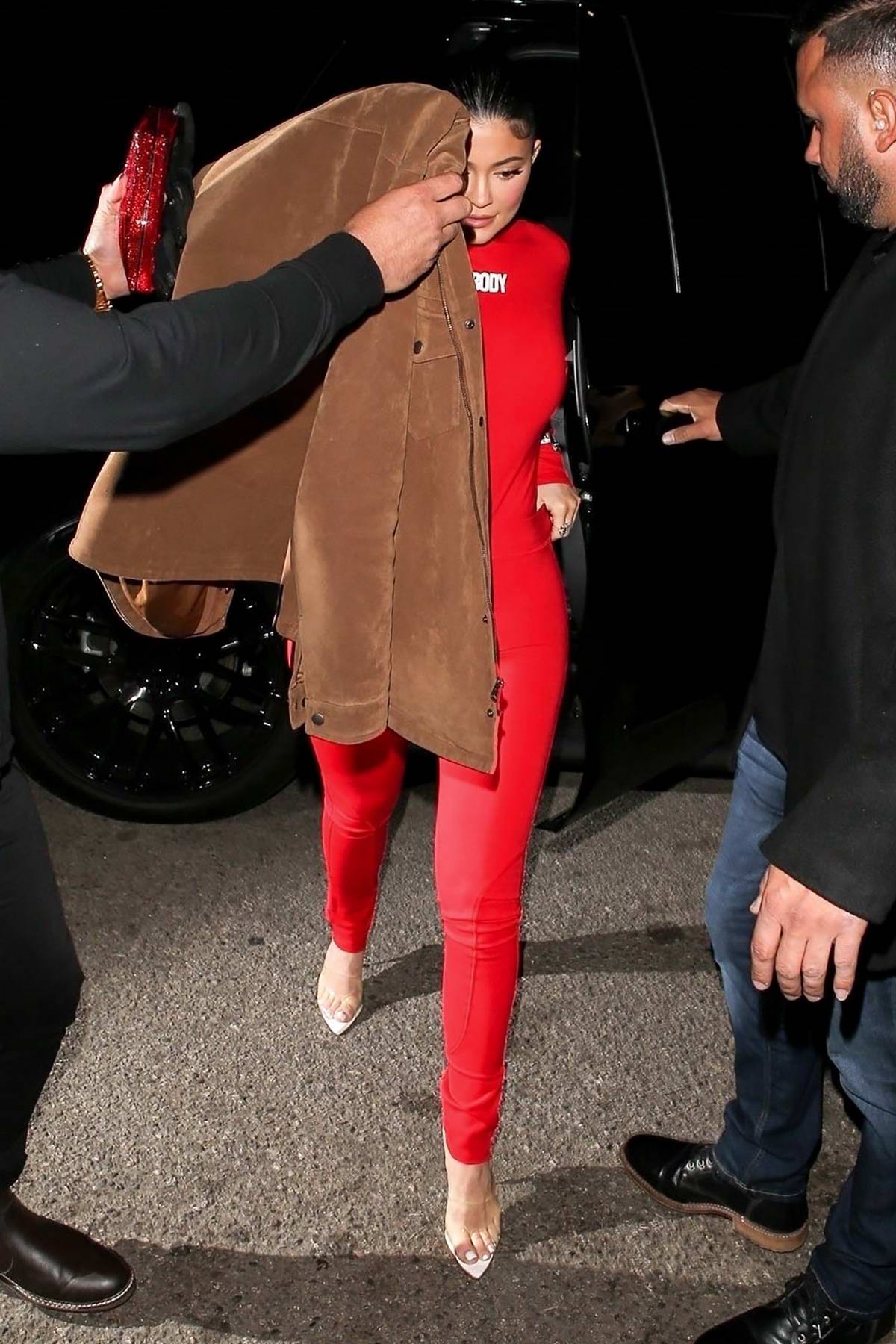 Kylie Jenner Shows Off Her Curves In A Red Jumpsuit As She Arrives At The Nice Guy In West 