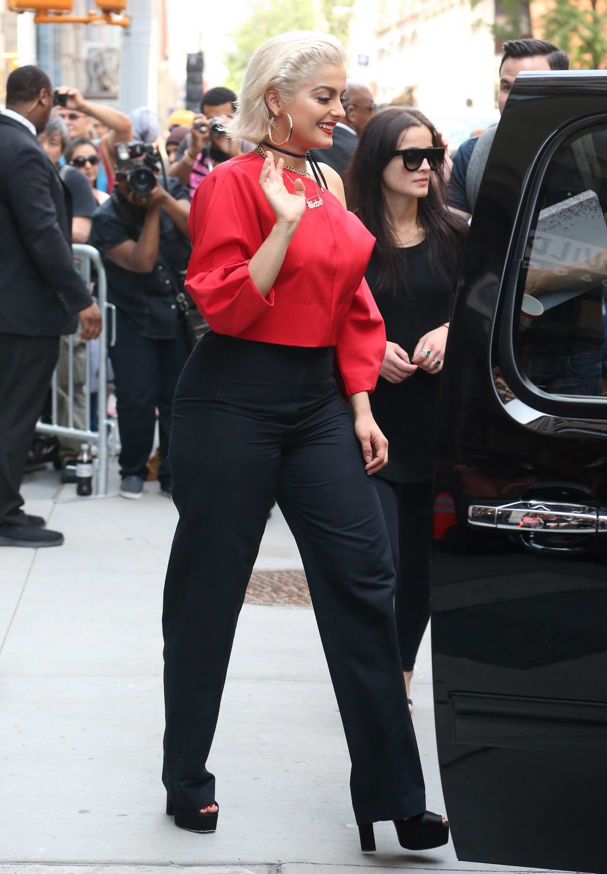 Gigi Hadid looks radiant in a denim shirt and black leggings as