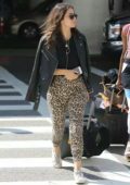 Chloe Bennet in black leather jacket and leopard print pants spotted at LAX Airport in Los Angeles