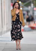 Danielle Campbell seen wearing a tan leather jacket over a black floral dress in New York City