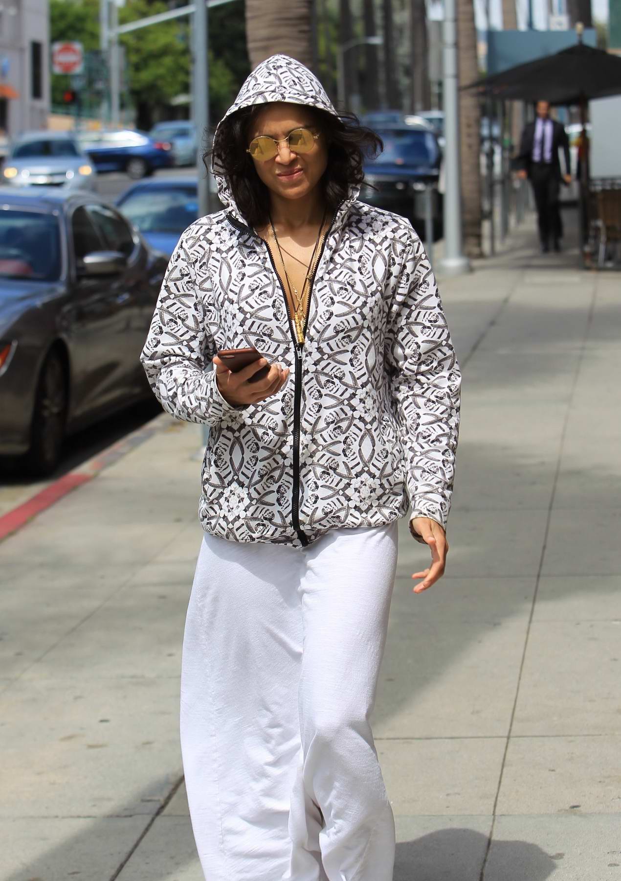 michelle rodriguez in a hoodie and a white maxi skirt while out for ...