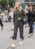 Toni Garrn grabs coffee and go for a walk with friends in Central Park, New York City