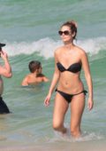 Yana Dubnik in a black bikini at the beach in Miami