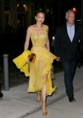 Gigi Hadid in a yellow dress returns to her apartments after a night out in New York