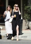 Kirsten Dunst in a black maxi dress enjoys a latte while out in Los Angeles