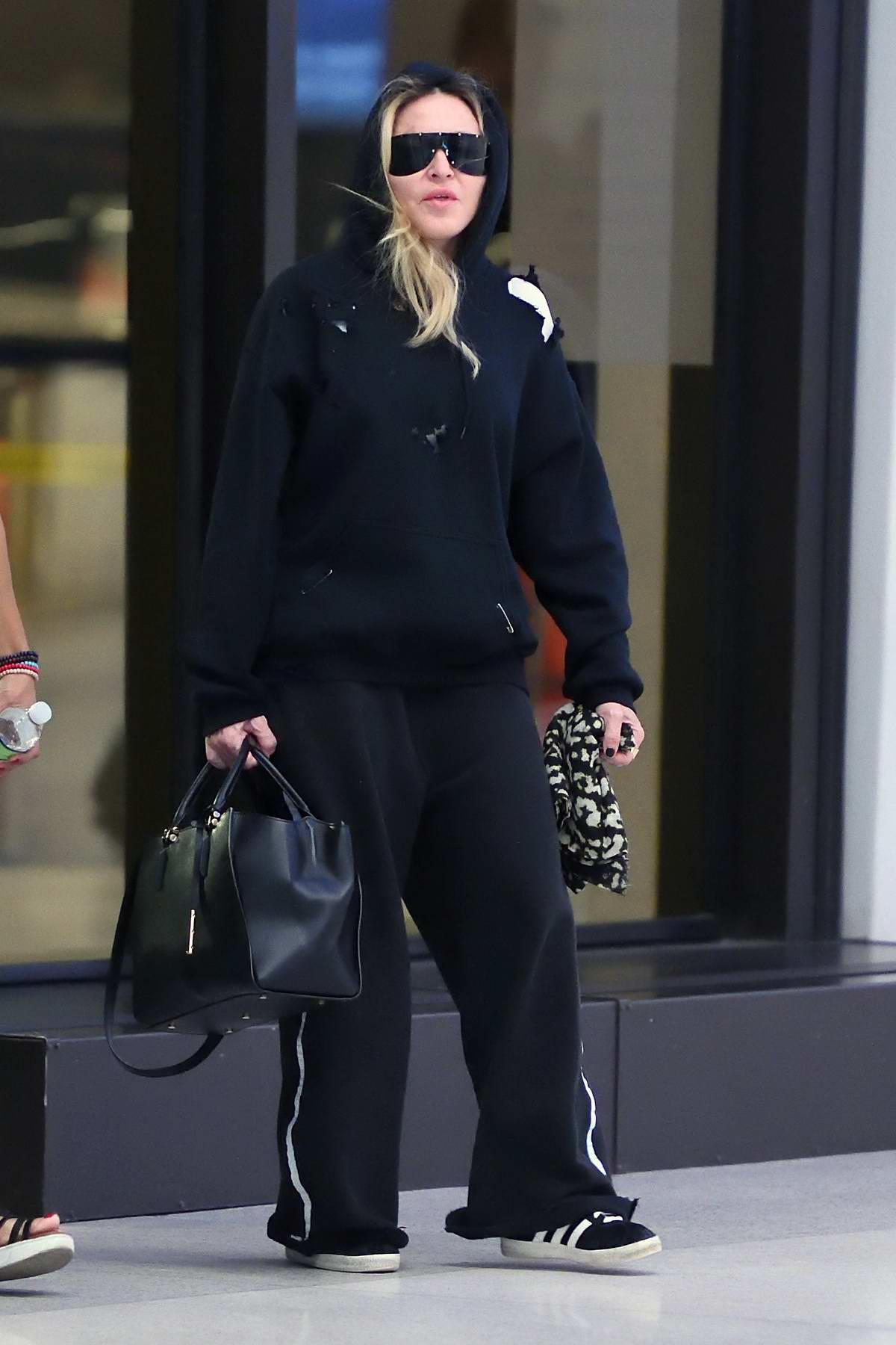 Madonna's in Louis Vuitton's Funky Sandals, Tracksuit at JFK Airport –  Footwear News