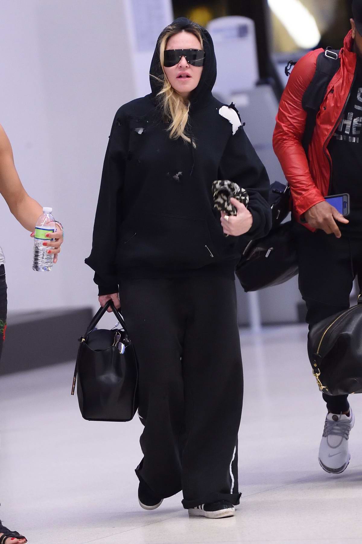 Madonna's in Louis Vuitton's Funky Sandals, Tracksuit at JFK