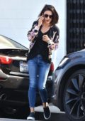 Mila Kunis busy on her phone while leaving a hair salon in Beverly Hills, Los Angeles