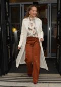 Rita Ora leaves BBC Radio Two in a white overcoat and rust coloured pants in London