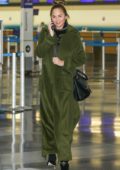 Chrissy Teigen in a green trench coat departs LAX Airport, Los Angeles