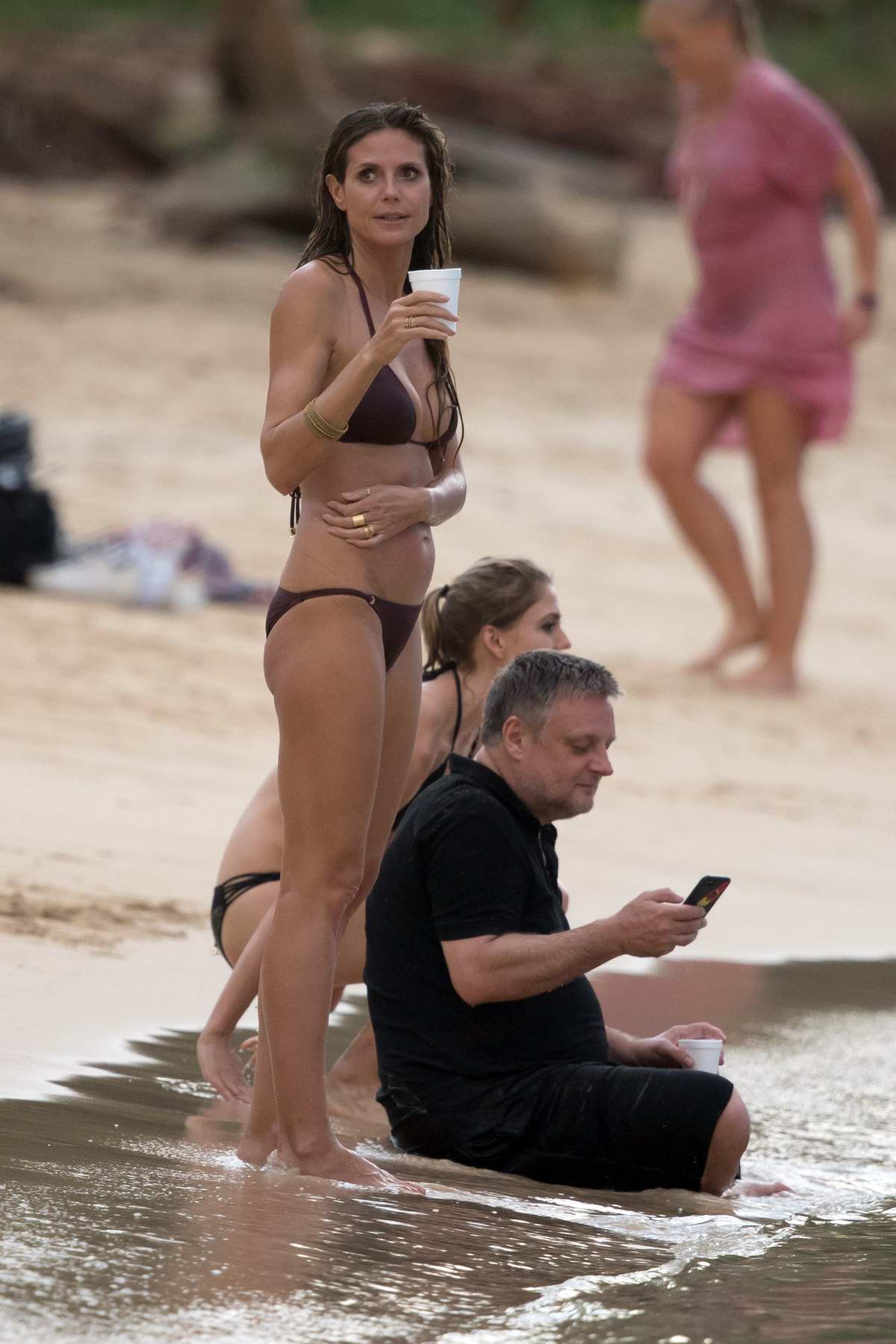 Heidi Klum in a bikini parties on the beach as Germany's Next Top Model  wraps shoot