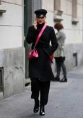 Michelle Hunziker dressed in all black with a pink purse while out in Milan, Italy