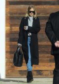 Rosie Huntington-Whiteley heads for a meeting in a long black coat with matching shoes in Los Angeles