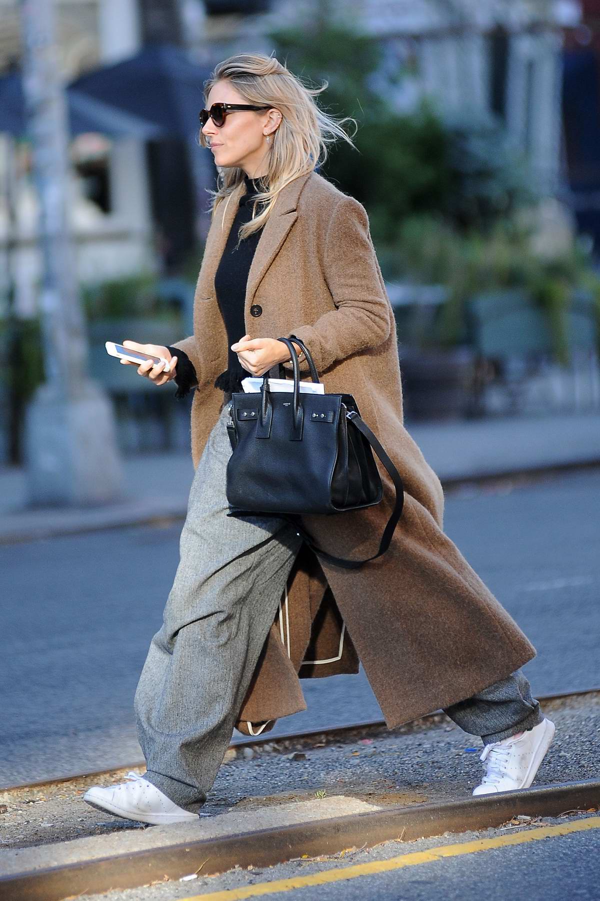 Sienna Miller in a overcoat spotted running errands in New York City