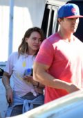 Hilary Duff gets escorted into the gym by her trainer in Los Angeles