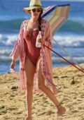 Lauren Silverman take the dogs for a walk wearing a swimsuit on the beach in Barbados