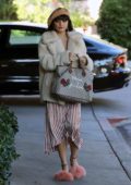 Vanessa Hudgens running errands wearing a cream faux fur jacket and a striped tea dress, Los Angeles