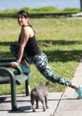 Andrea Calle gets some workout with her bulldog at a park in Los Angeles