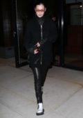 Bella Hadid steps out in a black comfy knit jacket with matching leather pants in New York City