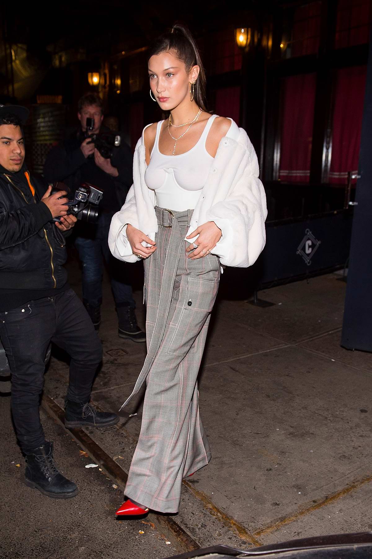 Bella Hadid wears a white jacket over a vest top while heading for a ...