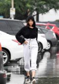 Olivia Culpo steps out in the rain wearing a black hoodie for some grocery shopping in Los Angeles