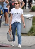 Olivia Wilde is seen out with a friend wearing classic white tee with blue jeans in West Hollywood, Los Angeles