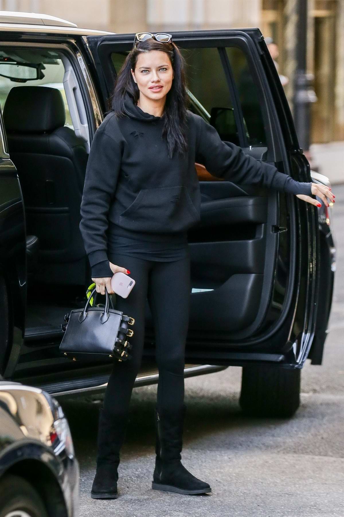 Bella Hadid wears a bright red sweater and black leggings while out on an  afternoon stroll