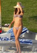 Alessandra Ambrosio wears a purple bikini while she spends a day relaxing on the beach with her family in The Bahamas