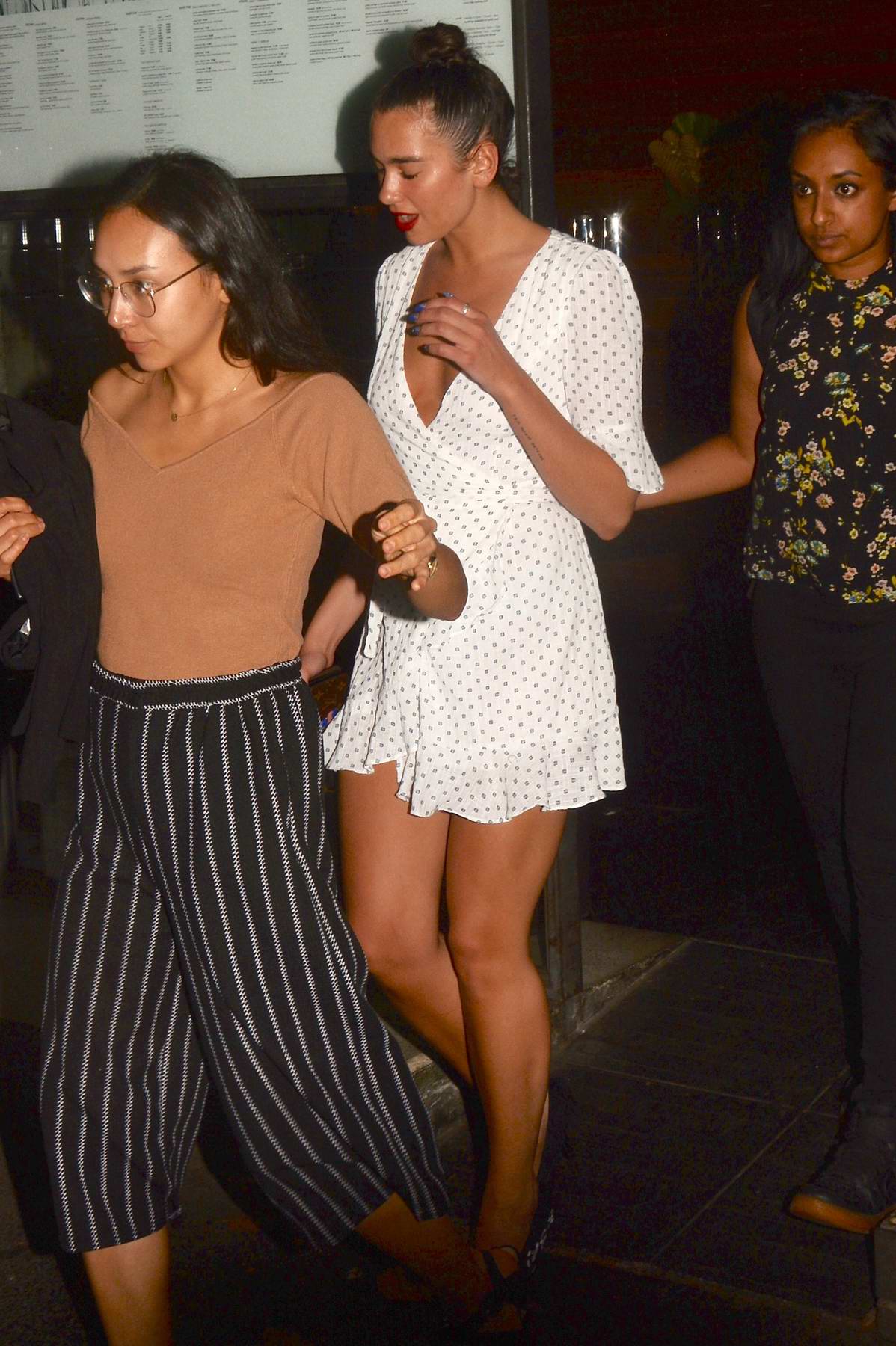 dua lipa covers her swollen mouth while leaving dinner in sydney