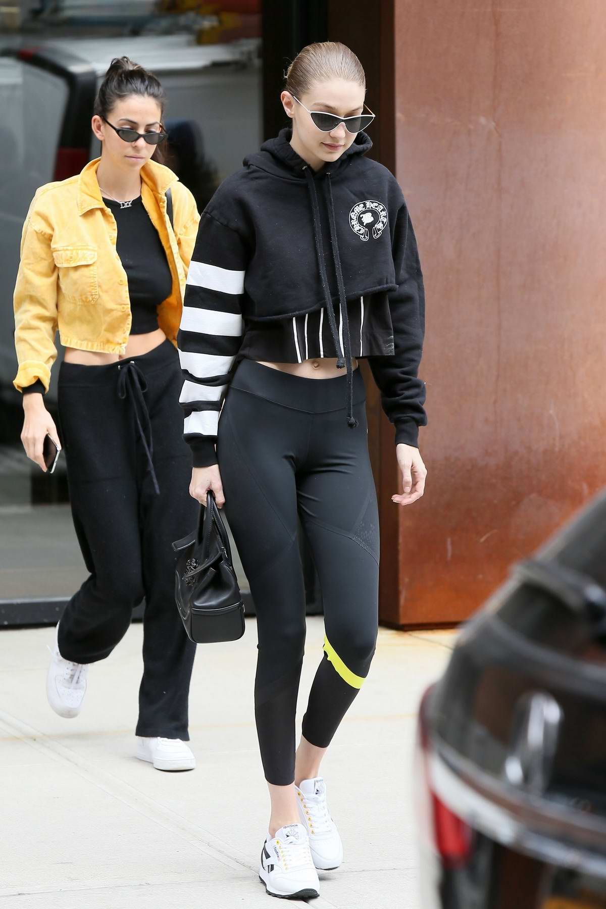Gigi Hadid dons an all black outfit with a Versace bag as she heads out in