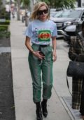 Hailey Baldwin wore a Gucci t-shirt tucked into green metallic drawstring pants with black boots while grabbing lunch at Zinque Restaurant in West Hollywood, Los Angeles
