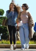 Selena Gomez steps out in a brown knit cardigan over a pink tube top and flared jeans as she grabs lunch with a friend at Nobu in Malibu, California