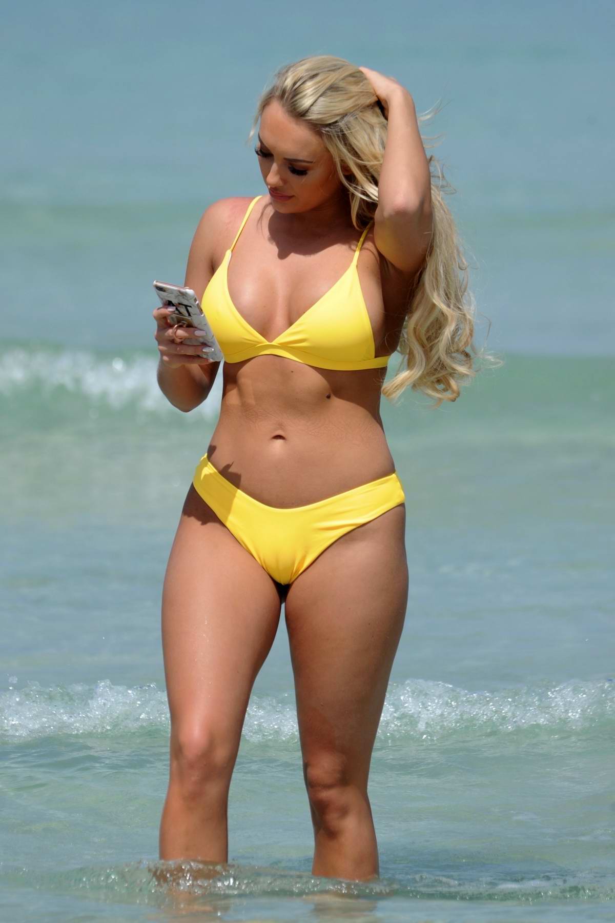 Amber Turner raises temperatures in a bright yellow thong bikini on luxury  holiday in Dubai