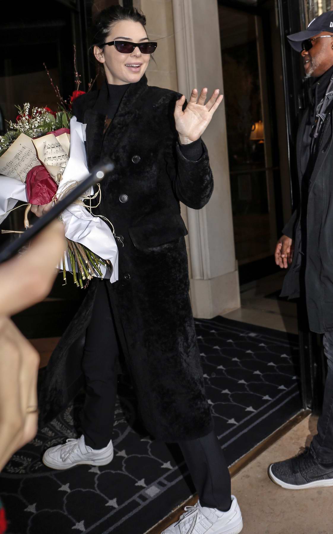 kendall jenner arrives at her hotel holding a bouquet of red roses in ...