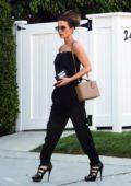 Kate Beckinsale gets ready on the go while walking to her car in an all black ensemble in Los Angeles