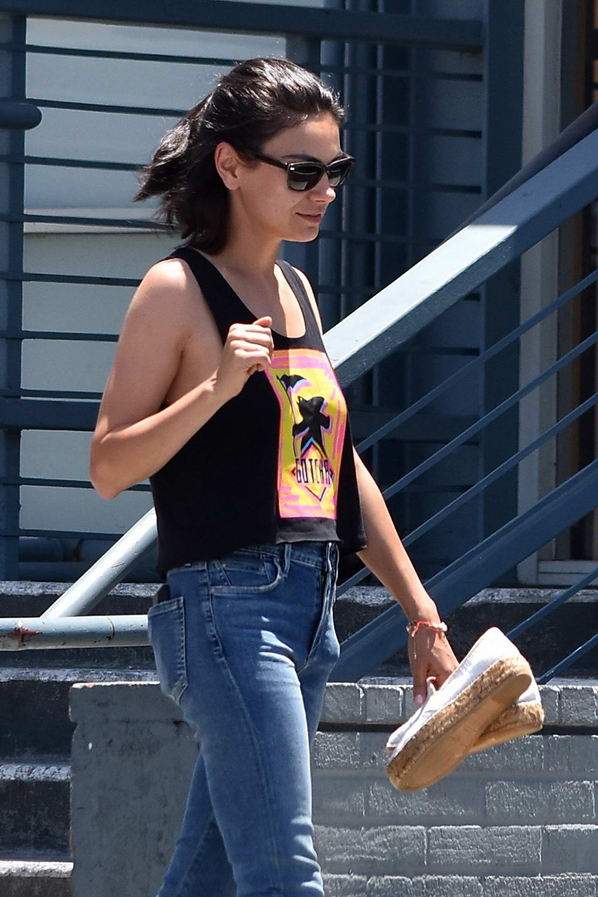 Mila Kunis wears a cropped 'Shark Man' tank top while visiting a nail salon  with a
