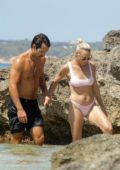 Robin Wright spotted in a light pink bikini as she gets in some PDA with husband Clement Giraudet while at the beach in Formentera, Spain