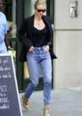 Rosie Huntington-Whiteley rocks black top with matching blazer and jeans with snakeskin boots as she heads out in New York City