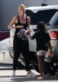 Charlize Theron steps out with her kids wearing her black leisurewear in Los Angeles