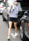 Charlotte McKinney wearing a sweatshirt and shorts as she leaves Kate Somerville covering her face in West Hollywood, Los Angeles