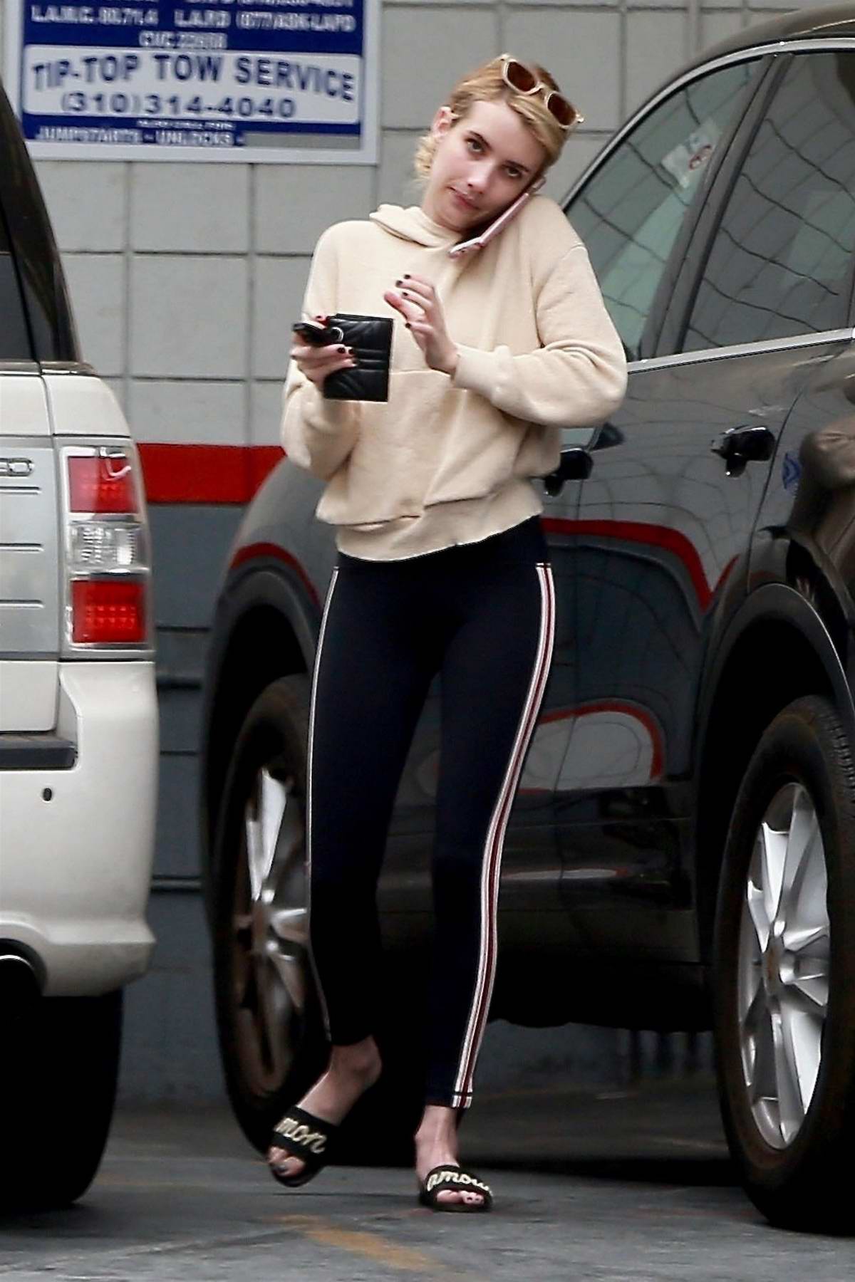 Emma Roberts wears a sweatshirt and leggings during her shopping