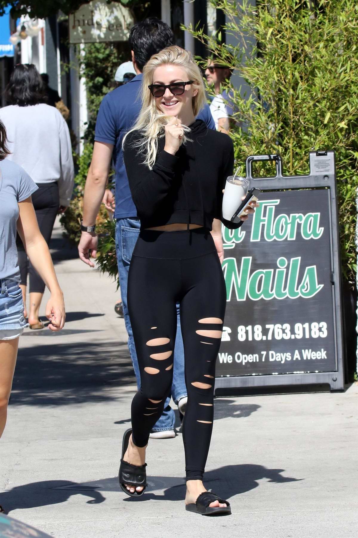 Julianne Hough steps out in a black crop top and ripped leggings while she  grabbed her
