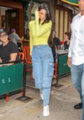 Kendall Jenner seen wearing a neon top with high waisted jeans and