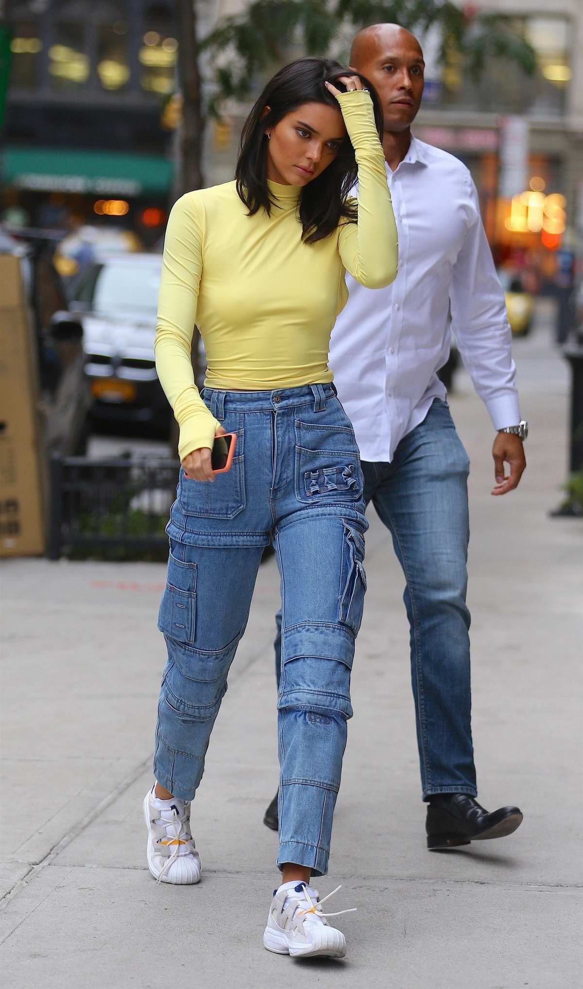 https://www.celebsfirst.com/wp-content/uploads/2018/09/kendall-jenner-seen-wearing-a-neon-top-with-high-waisted-jeans-and-sneakers-as-she-leaves-bar-pitti-in-new-york-city-080918_9.jpg