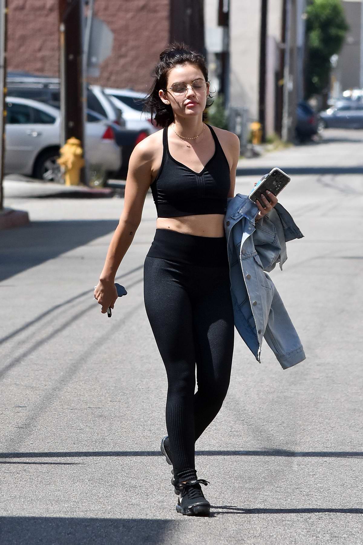 Lucy Hale heads out in a black sports bra and leggings after a